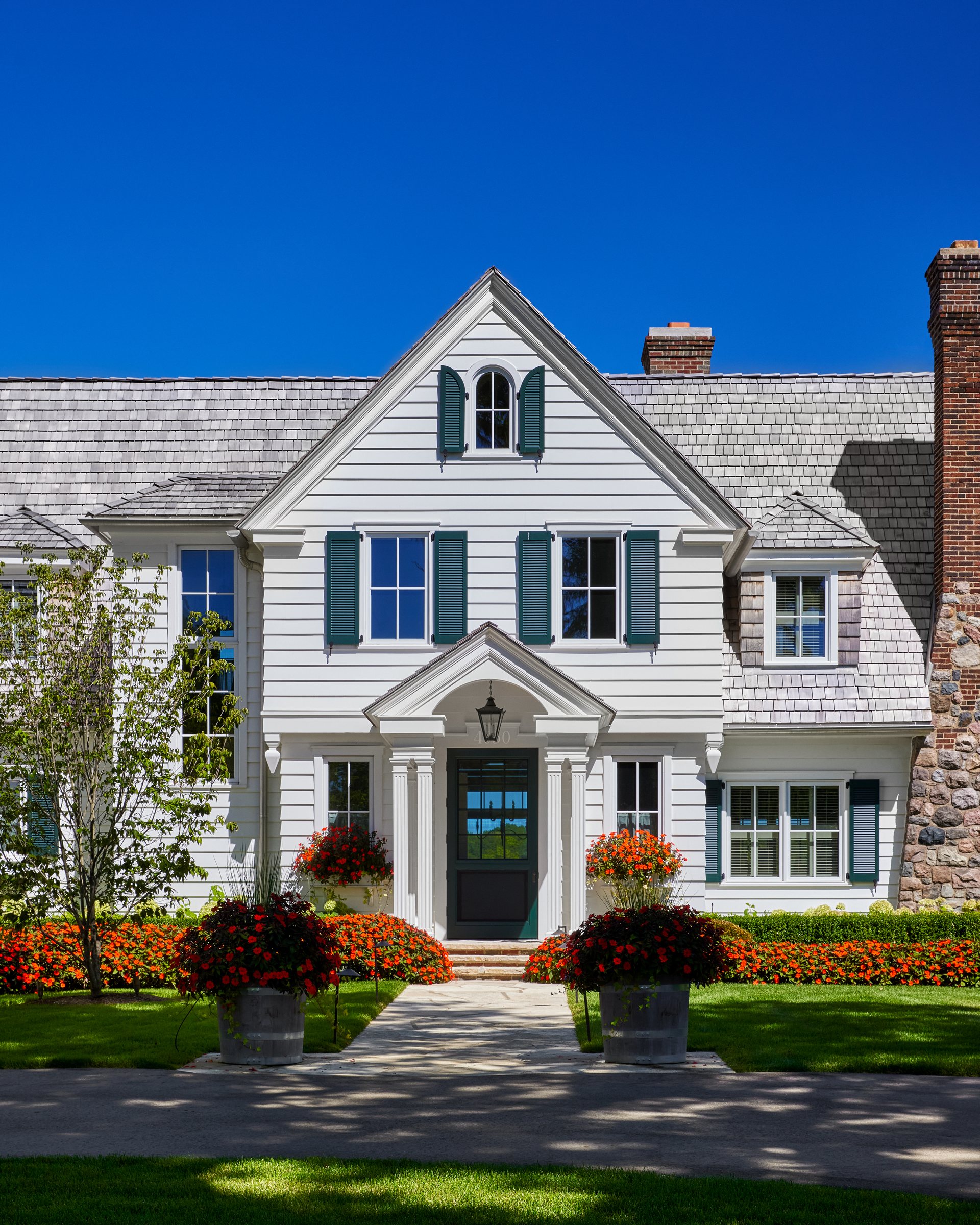 Shingle-style lakefront custom home with gabled dormers, built by Mosher Dolan