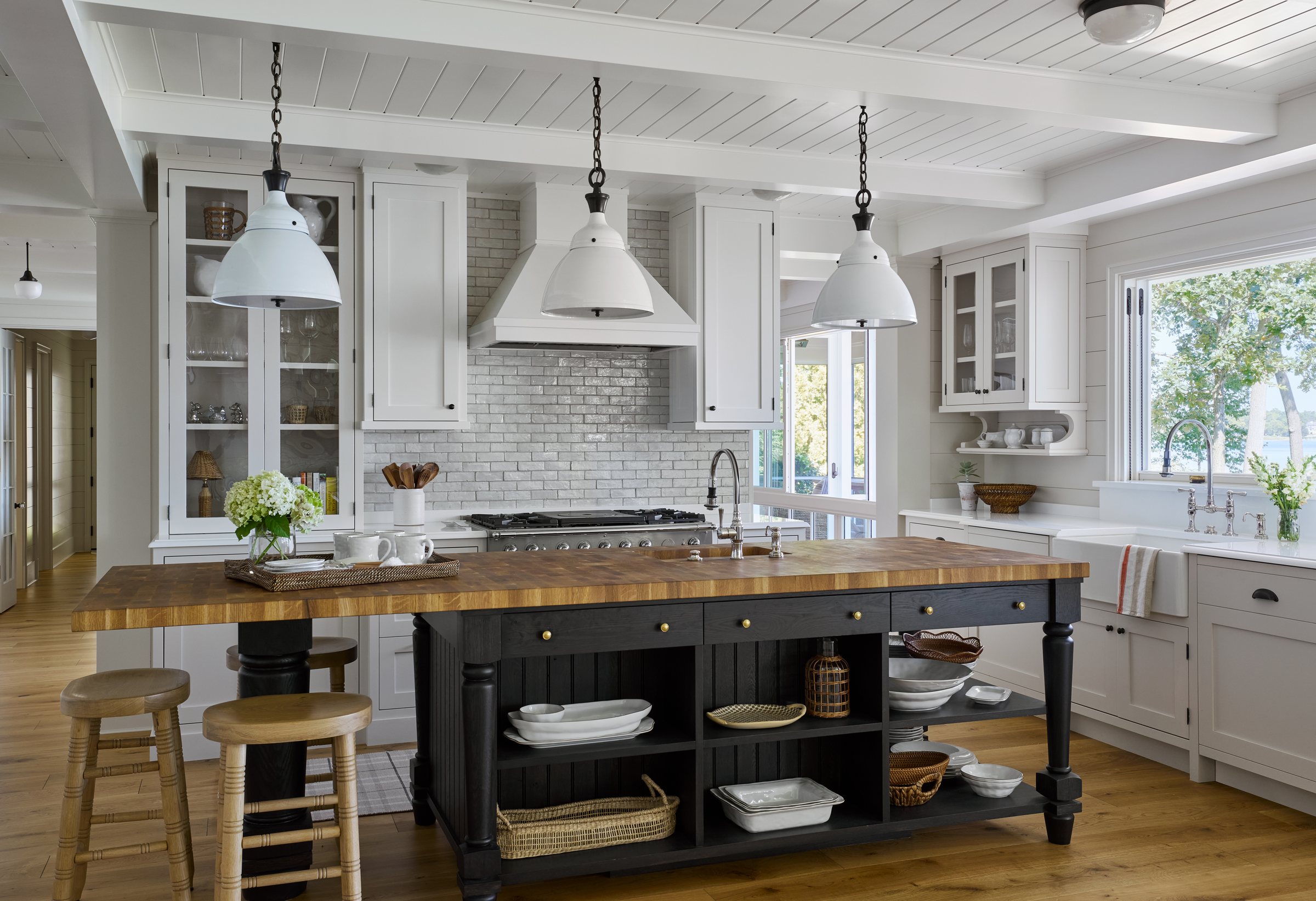 Custom kitchen with a dark island and white cabinetry