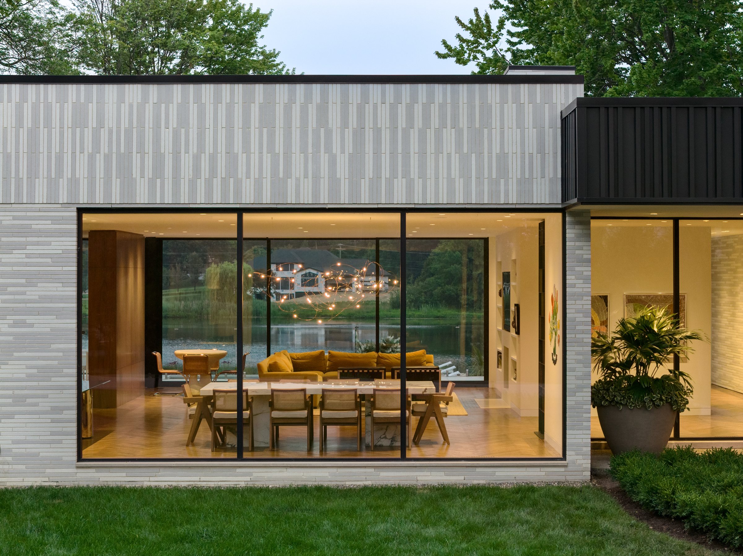 Evening view of the house glowing through the trees