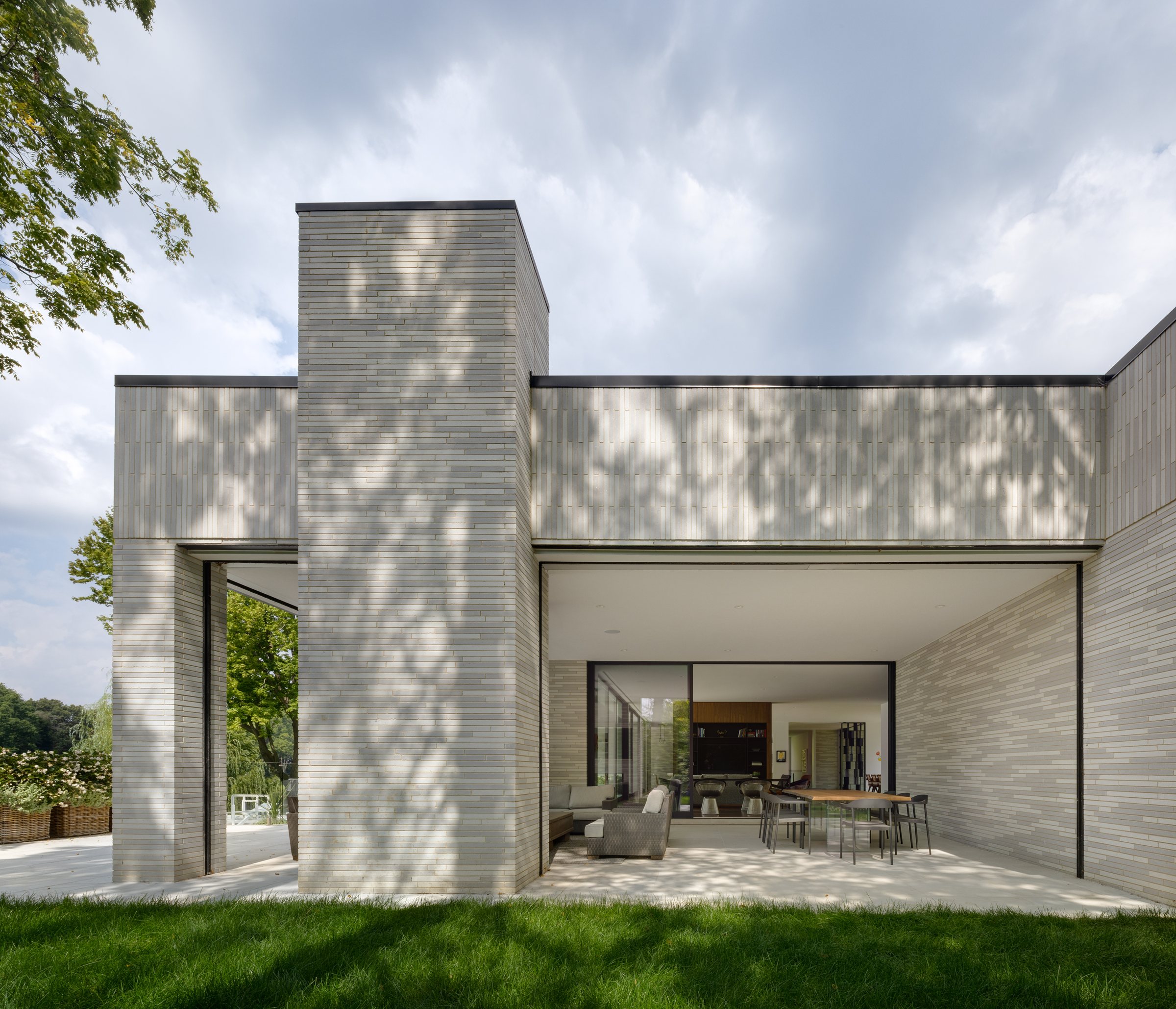 Brick chimney and deep roof overhang over the covered terrace