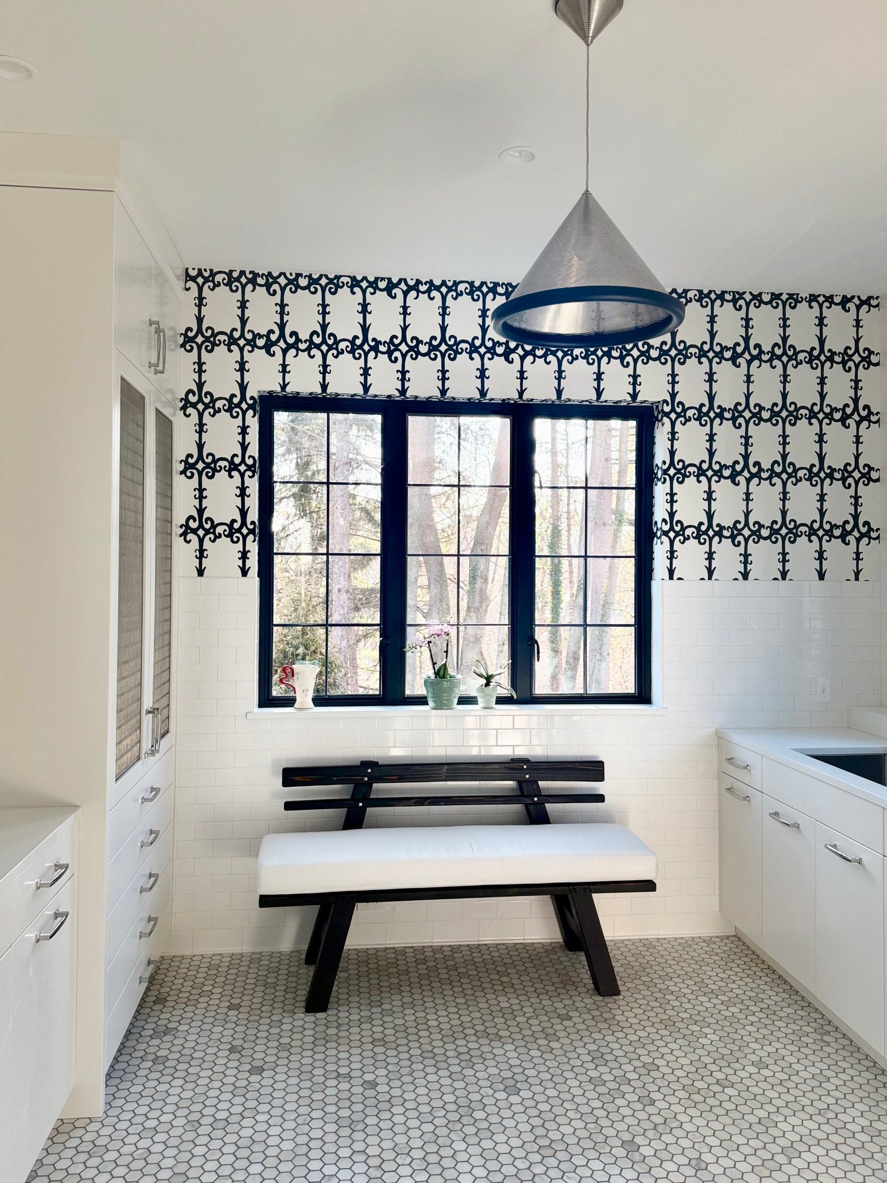 Breakfast nook with patterned wallpaper, subway tile, steel windows, and a hex tile floor