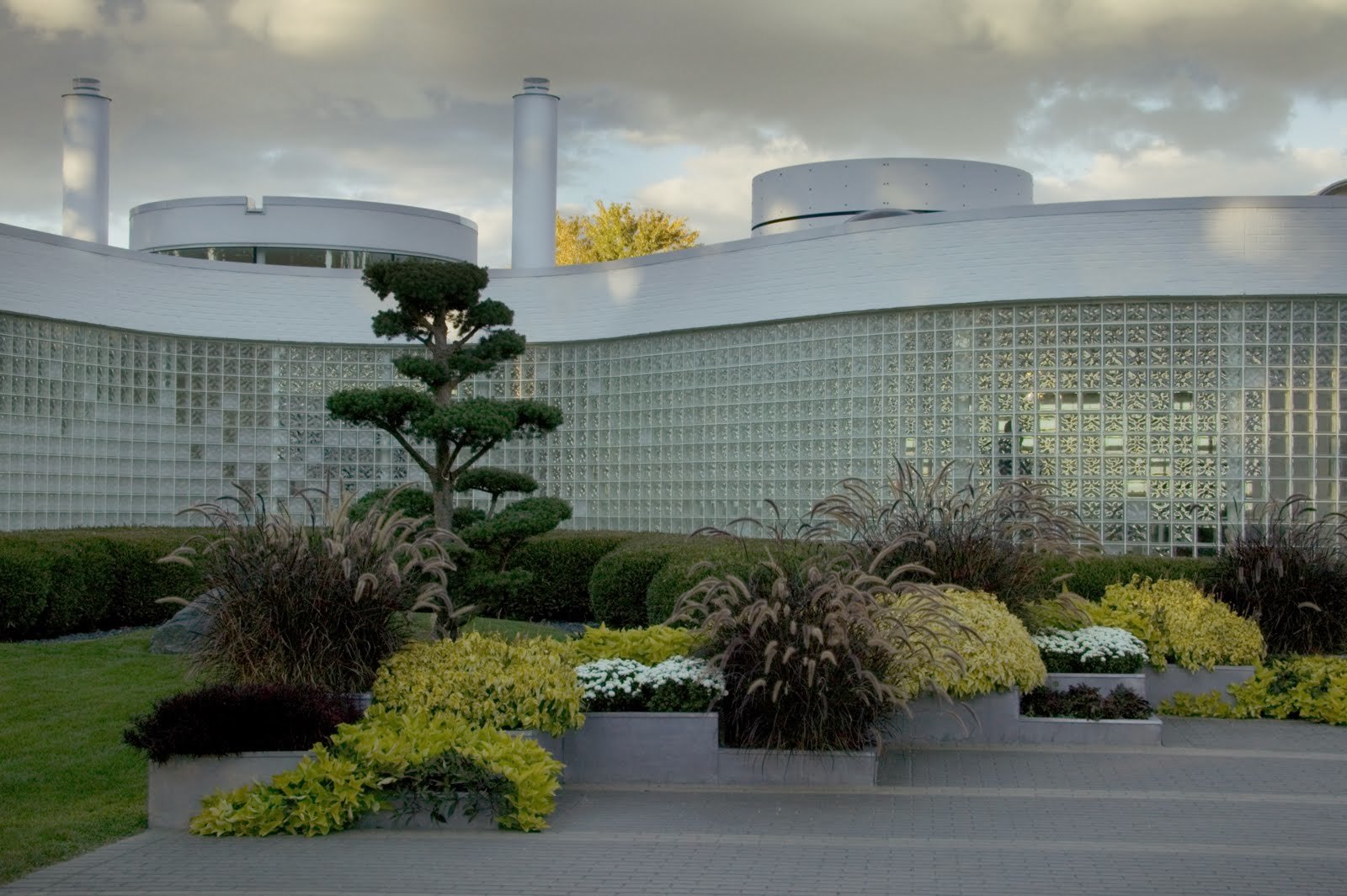 The glass-block wall and rooftop drums above the planted terraces