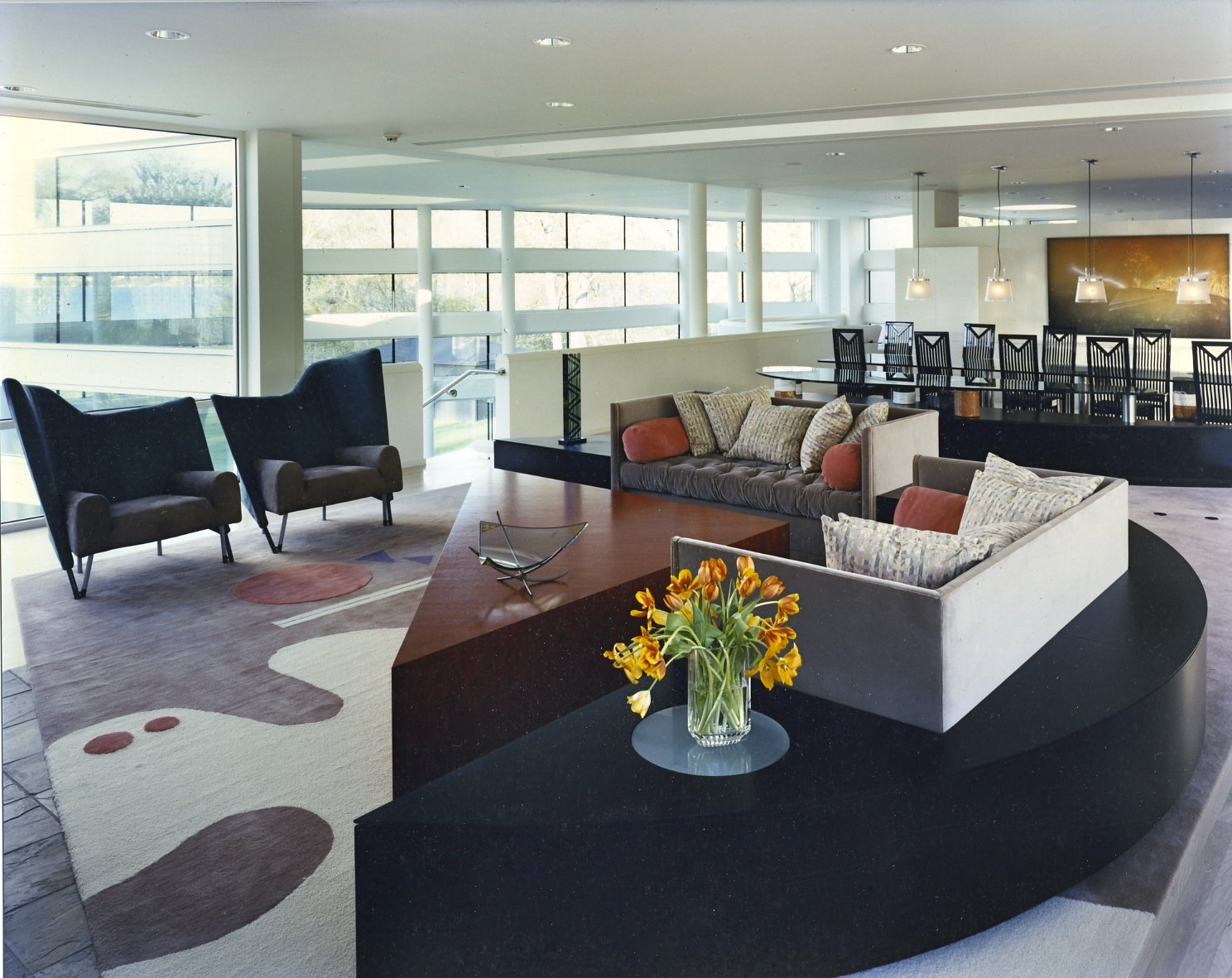 Seating on the curved granite deck, with the dining table beyond