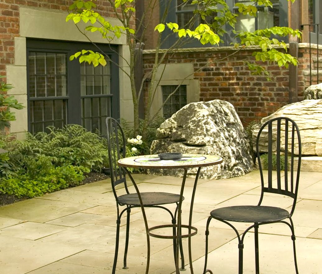 A bistro table in the walled courtyard