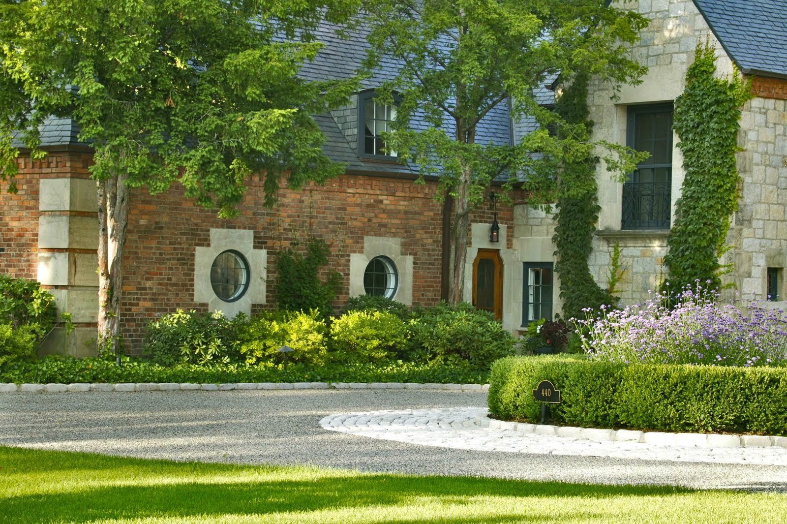Archive 008: brick and limestone with ivy, a paved motor court in front