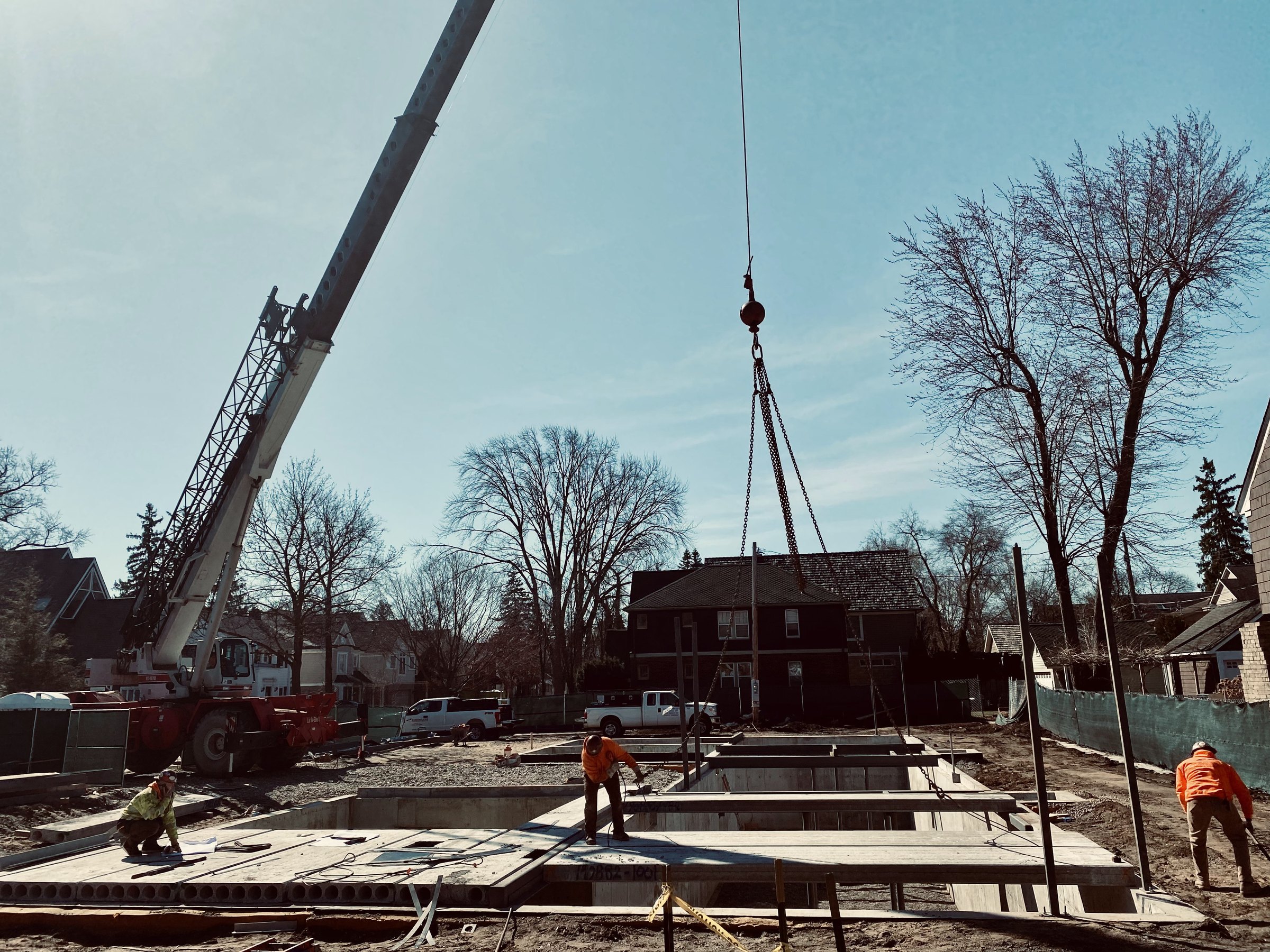 A crane setting steel on a Mosher Dolan job site