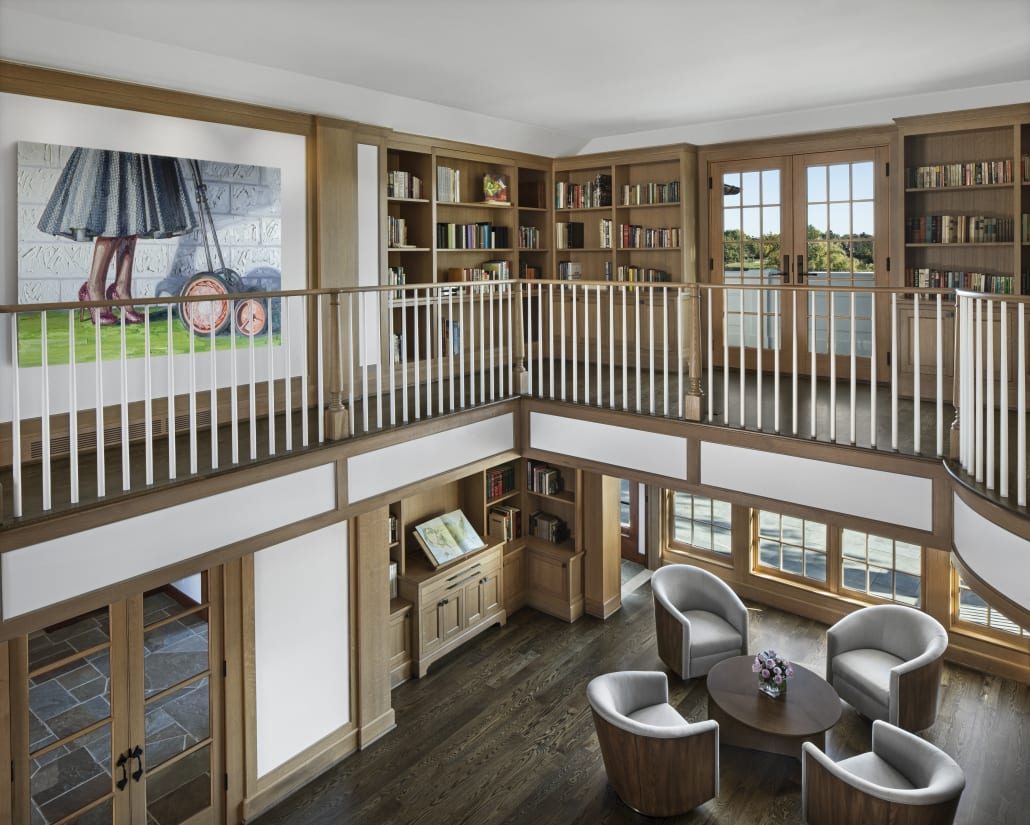 Library balcony with oak millwork and a view to the lake